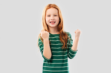 Image showing smiling red haired girl celebrating success