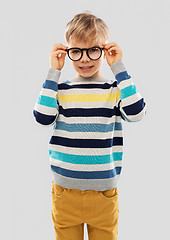 Image showing smiling boy in glasses and striped pullover