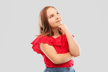 Image showing beautiful girl in red shirt thinking or dreaming