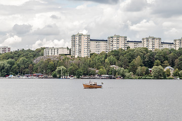 Image showing Modern city on a green riverside