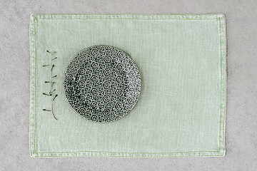 Image showing Green ceramic plate on linen placemat