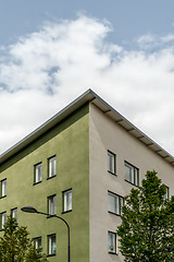 Image showing Corner of a green building and trees