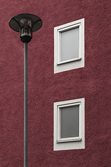 Image showing Streetlamp in front of a dark red building