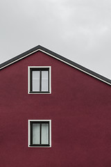 Image showing Facade and roof of a dark red house