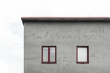 Image showing Facade of a gray house with red windows