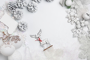 Image showing Christmas decorative composition of toys on a white background surrealism. Top view