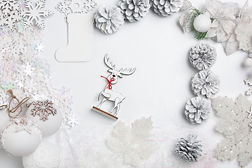 Image showing Christmas decorative composition of toys on a white background surrealism. Top view