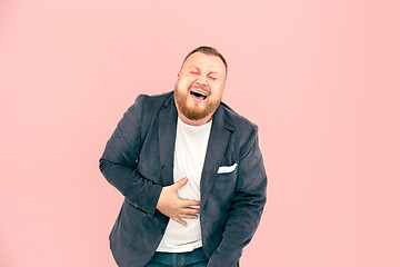 Image showing Young man with microphone on pink background, leading with microphone