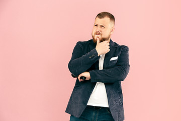 Image showing Young man with microphone on pink background, leading with microphone