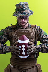 Image showing solder holding american football ball