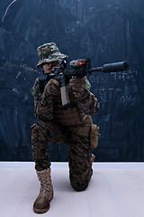 Image showing soldier in action aiming laseer sight optics