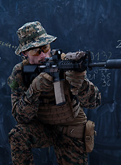 Image showing soldier in action aiming laseer sight optics