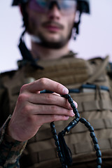 Image showing soldier praying tespih