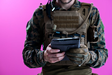 Image showing soldier using tablet computer closeup