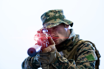 Image showing soldier in action aiming laseer sight optics