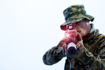 Image showing soldier in action aiming laseer sight optics