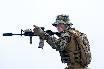 Image showing soldier in action aiming laseer sight optics