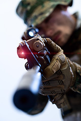 Image showing soldier in action aiming laseer sight optics