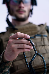 Image showing soldier praying tespih