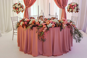 Image showing Beautifully decorated wedding table with flowers and candles