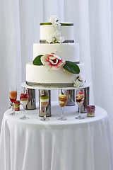 Image showing Big wedding cake with three storey decorated by white and pink r