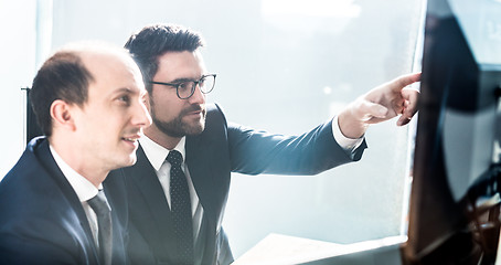 Image showing Business team analyzing data at business meeting in modern corporate office.