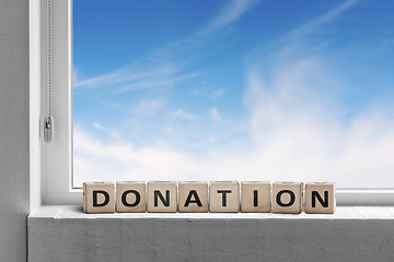 Image showing Donation sign standing in a window