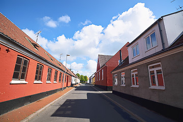 Image showing Empty street with red buildings