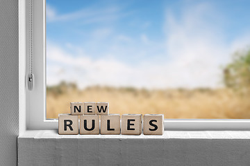 Image showing New rules sign in a window with a view to fields