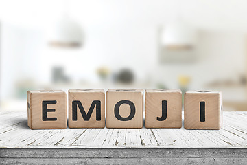 Image showing The word emoji on a wooden sign in a bright room