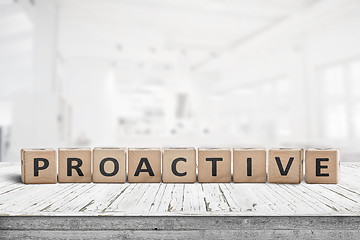 Image showing Proactive sign on a wooden table in a bright office