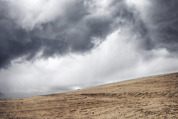 Image showing Sandstorm in a dry desert under a cloudy sky