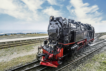 Image showing Locomotive on railroad tracks at a station