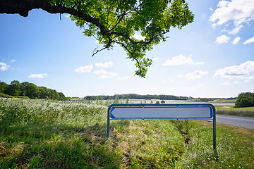 Image showing Road sign with an arrow in idyllic nature