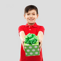 Image showing smiling boy in red t-shirt with birthday gift box