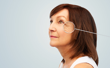 Image showing senior woman with zoomed eye wrinkles