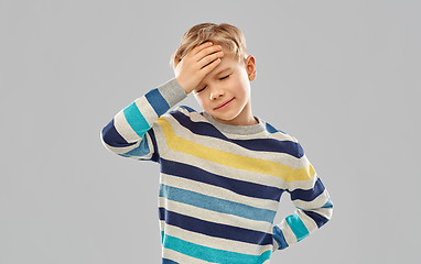 Image showing sick boy in red t-shirt suffering from headache