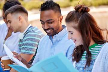 Image showing group of happy students with notebooks outdoors