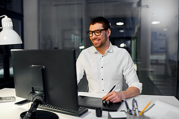 Image showing designer with computer and pen tablet at office