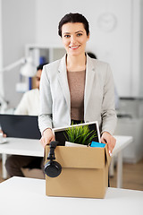 Image showing happy businesswoman with personal stuff at office