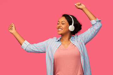 Image showing african woman in headphones listening to music