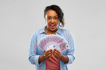 Image showing surprised african american woman with euro money