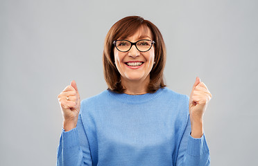 Image showing portrait of happy senior woman celebrating triumph