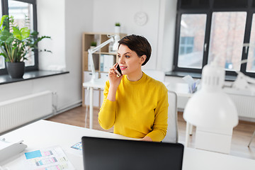 Image showing happy ui designer calling on smartphone at office