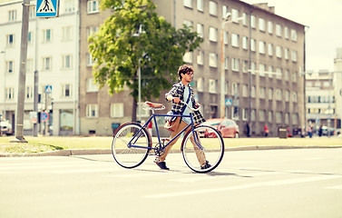 Image showing young man with fixed gear bicycle on crosswalk