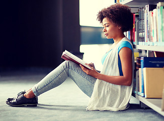 Image showing african student girl reading book at library