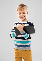 Image showing boy in striped pullover with tablet pc computer