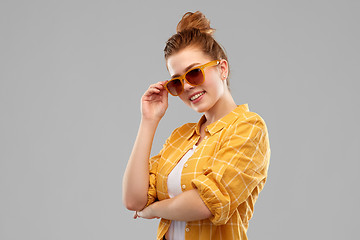 Image showing smiling red haired teenage girl in sunglasses