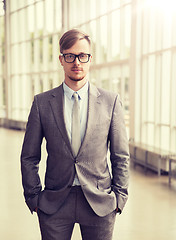 Image showing young businessman in suit and glasses at office