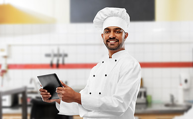 Image showing indian chef with tablet pc at restaurant kitchen